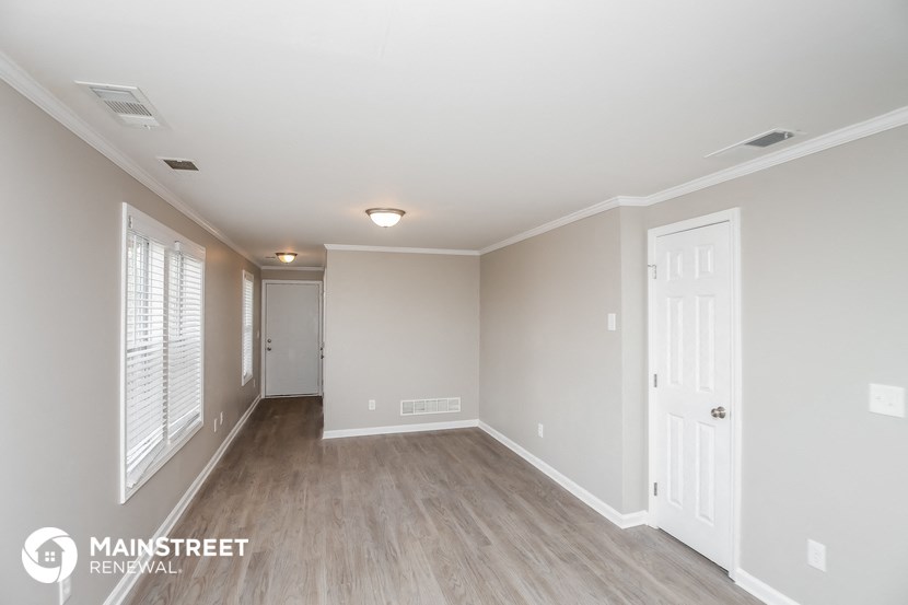 the living room and dining room of an apartment