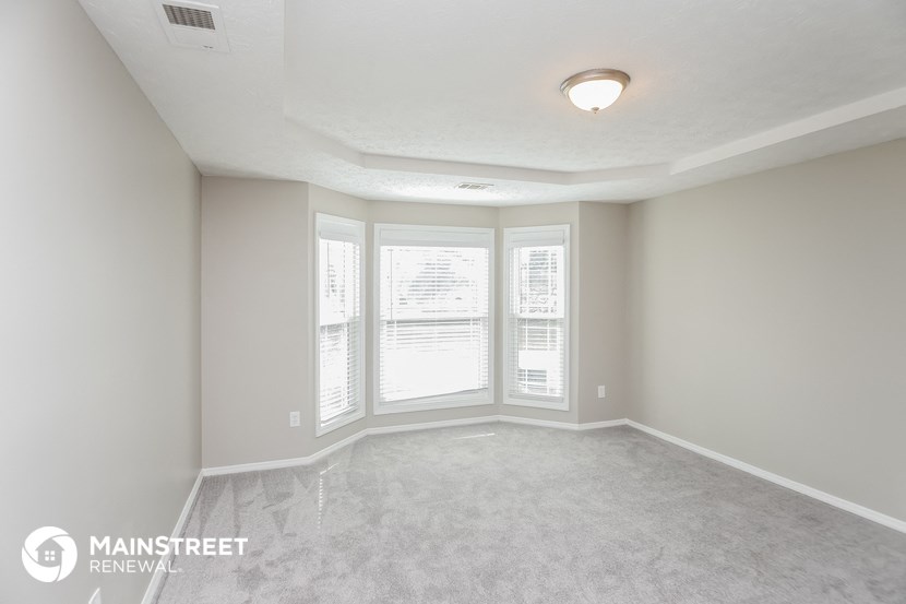 an empty living room with a large window