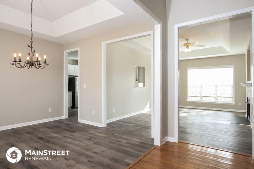 the living room and dining room with the kitchen in the background