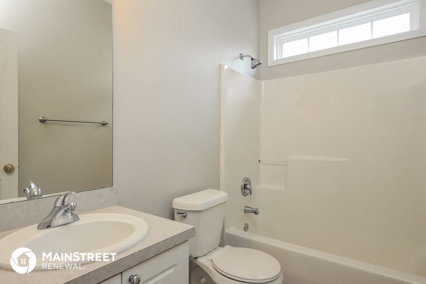 a bathroom with a sink and a toilet and a shower