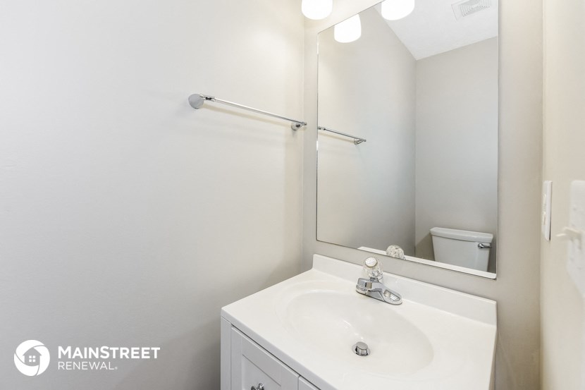 a bathroom with a sink and a mirror and a toilet