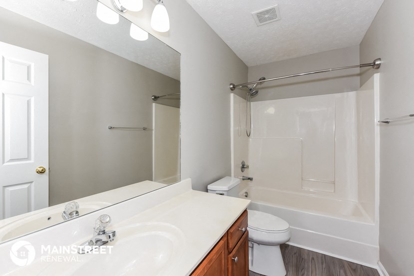 a bathroom with a sink and a shower and a toilet