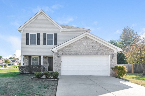 a white house with a white garage door