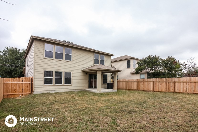 a house with a yard and a wooden fence