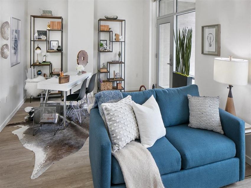 a living room with a blue couch and a table
