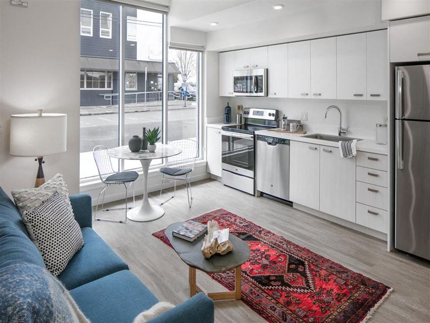 a living room with a couch and a kitchen
