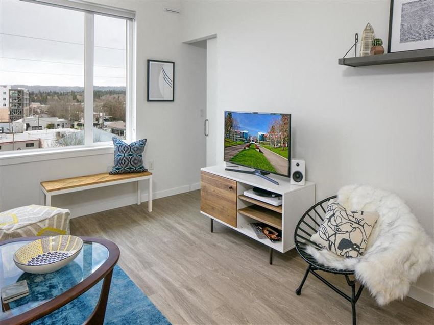 a living room with a large window and a television