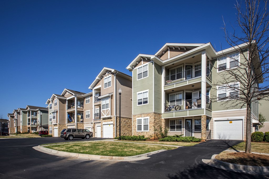 an apartment building with a car parked in front of it