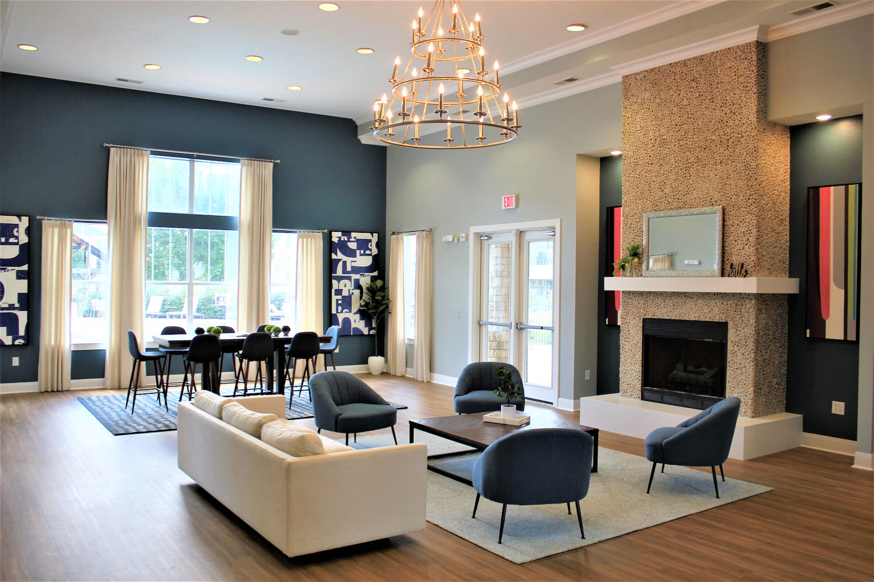 a living room with couches chairs and a fireplace   and a dining room