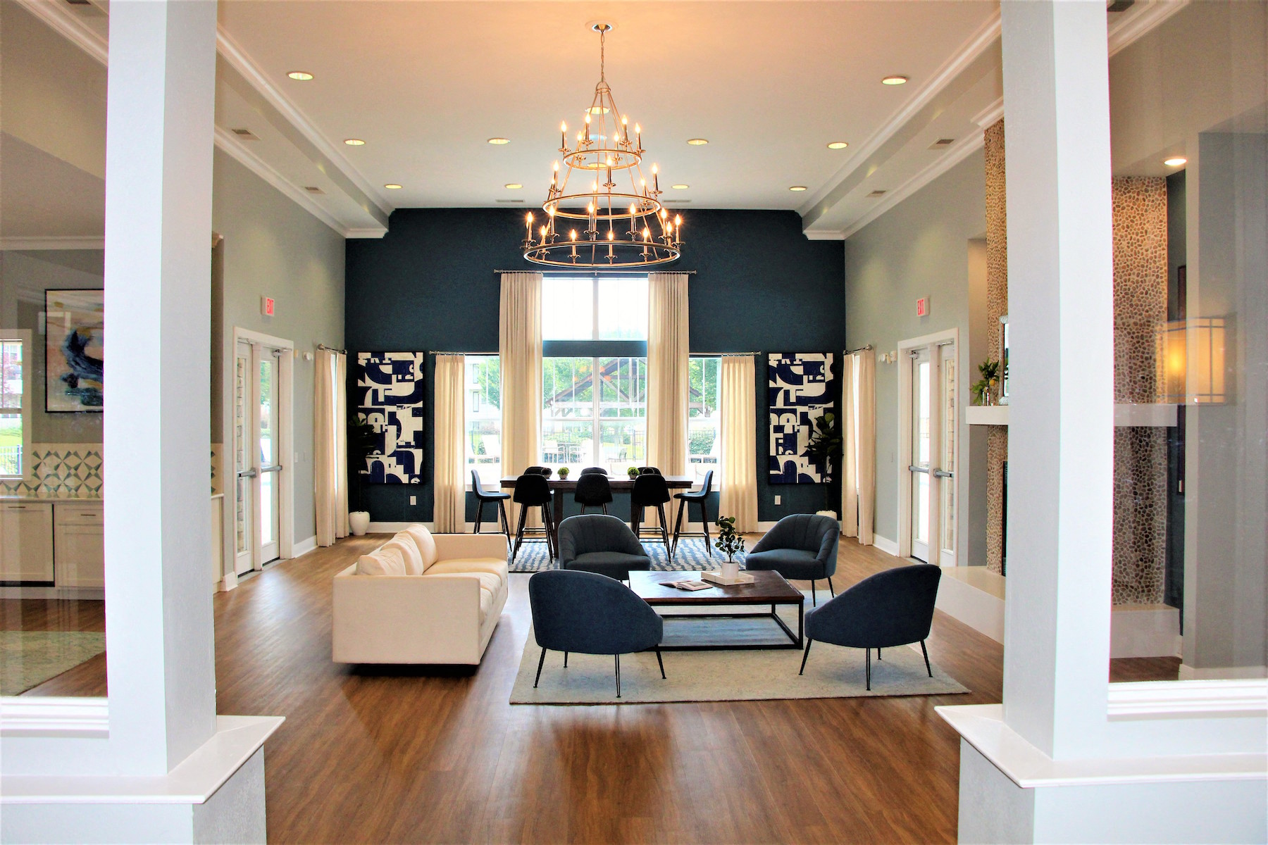 a living room with blue walls and a large chandelier