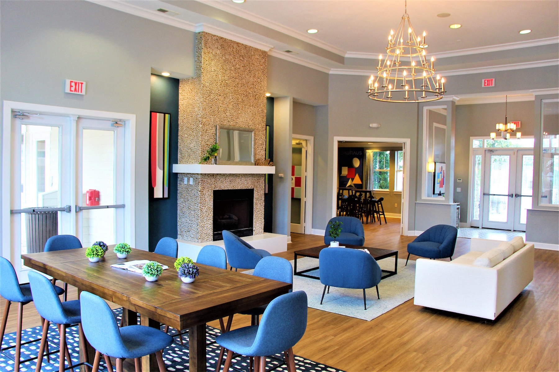 a living room with a table and chairs and a fireplace