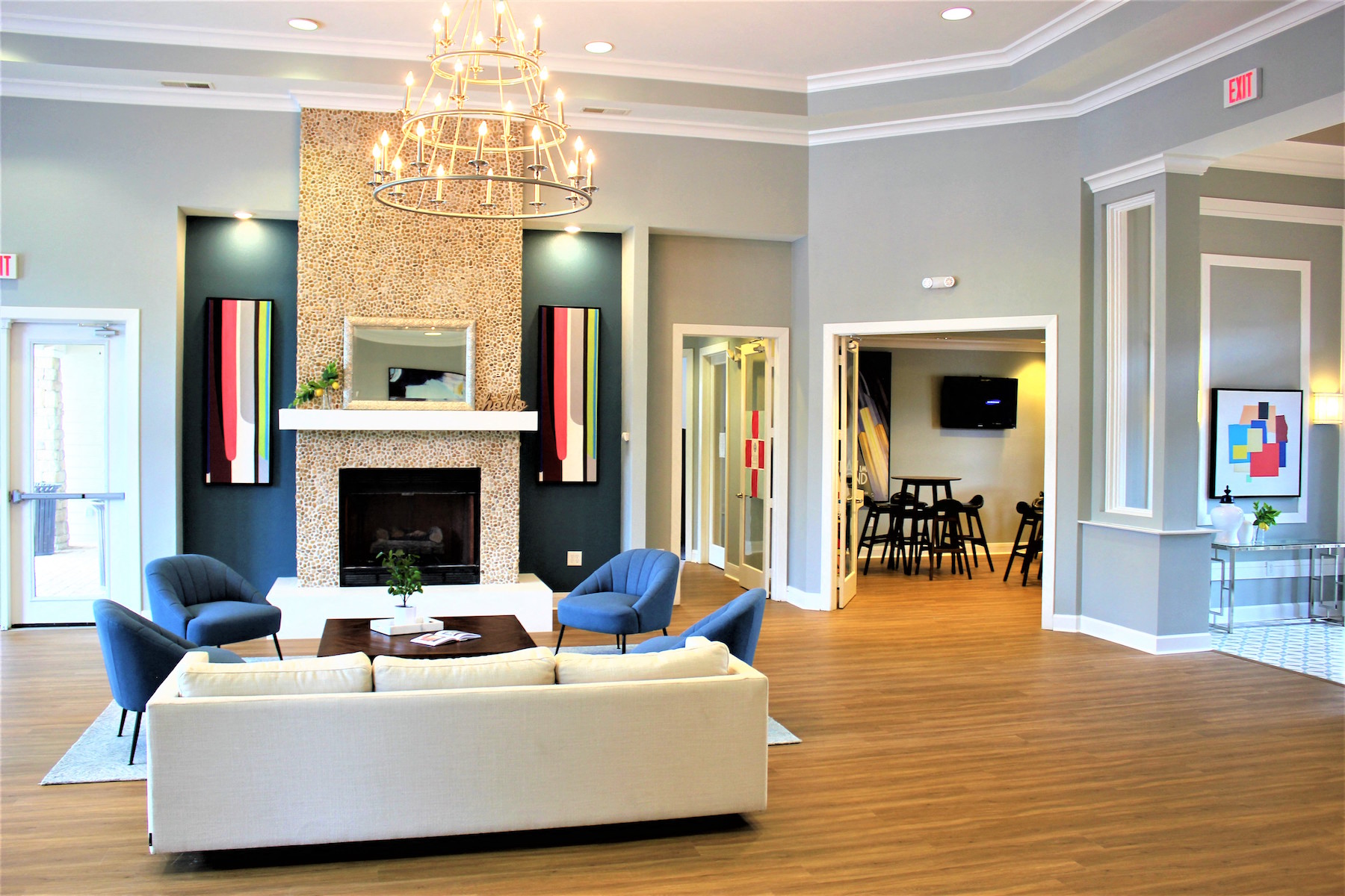 a living room with a couch and a table in front of a fireplace
