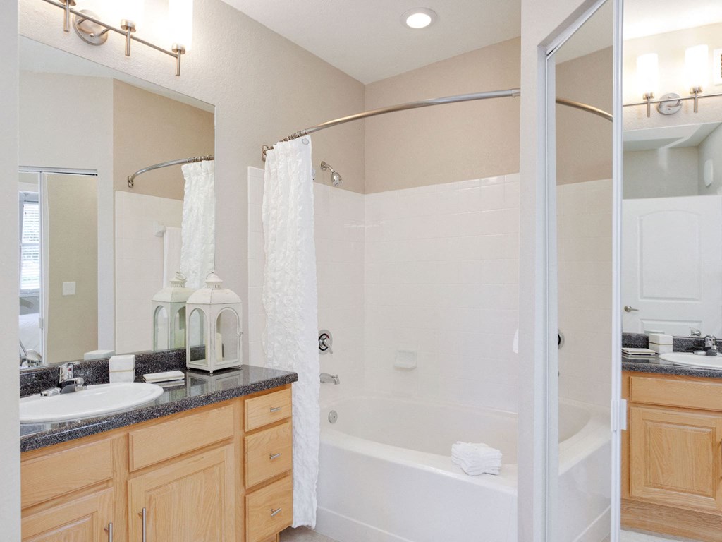 a bathroom with a shower and a sink and a mirror