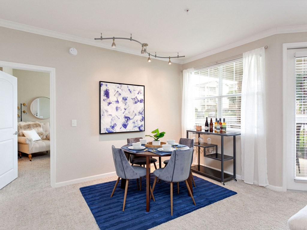 a dining room with a table and chairs