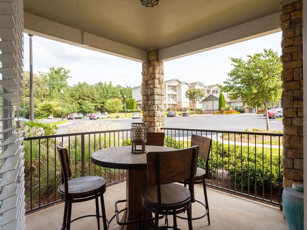 a patio with a table and chairs on a balcony