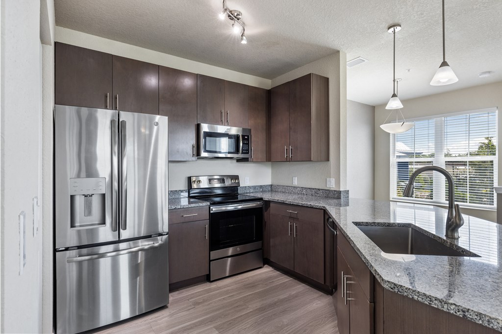 an expansive kitchen with stainless steel appliances and granite counter tops