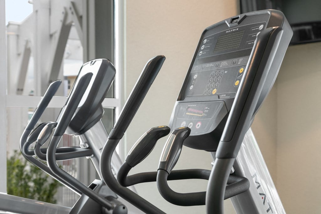 a row of elliptical machines in a gym