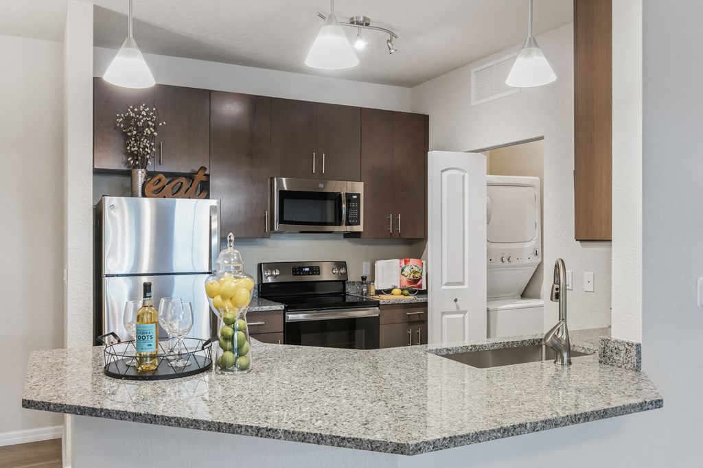 a kitchen with stainless steel appliances and granite counter tops