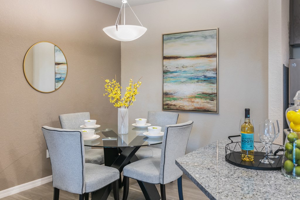 a dining room with a glass table and chairs