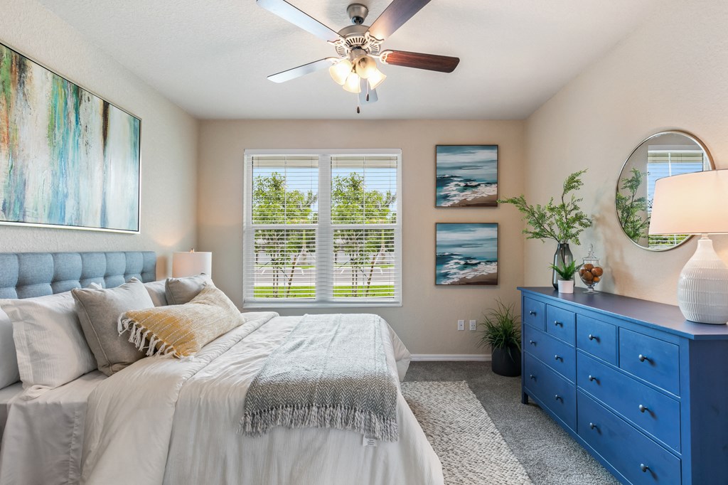 a bedroom with a bed and a ceiling fan