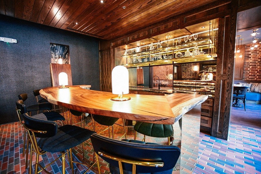 a dining room with a table and chairs and a bar