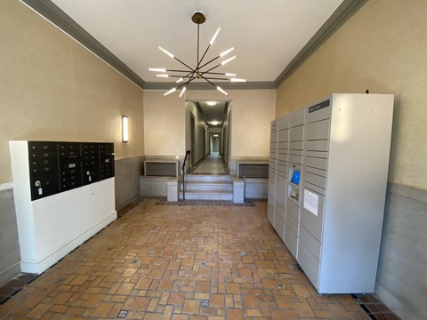 a view of the hallway of a building with vending machines and a ceiling fan