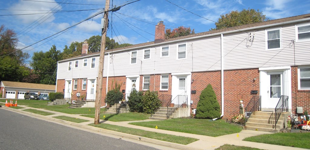 a row of houses on the corner of a street