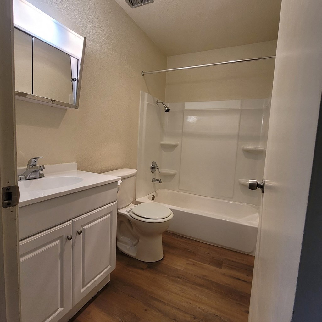 a bathroom with a toilet and a sink and a shower