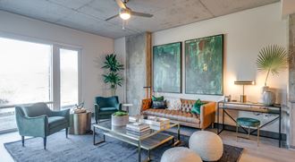 a living room with a couch and chairs and a coffee table
