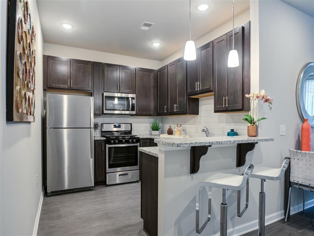 a kitchen with a bar and stainless steel appliances