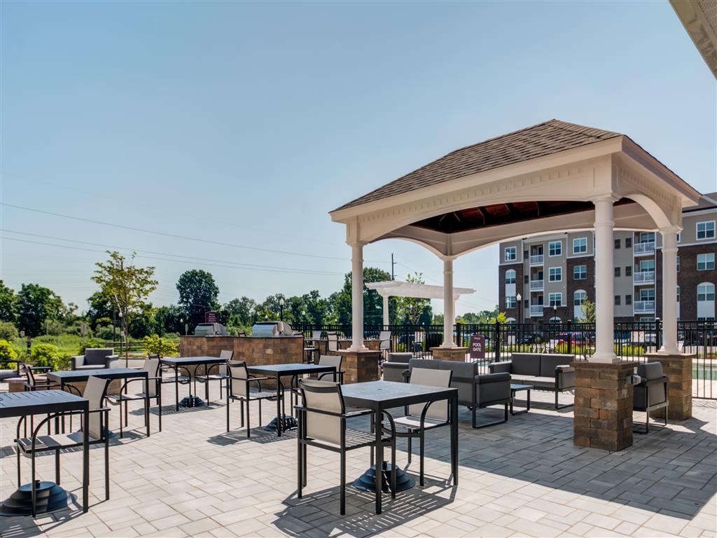 a covered patio with tables and a pavilion