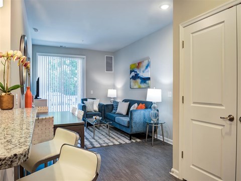 a living room and dining room with a couch and a table