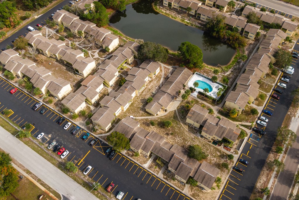 an aerial view of a neighborhood with houses and a body of water
