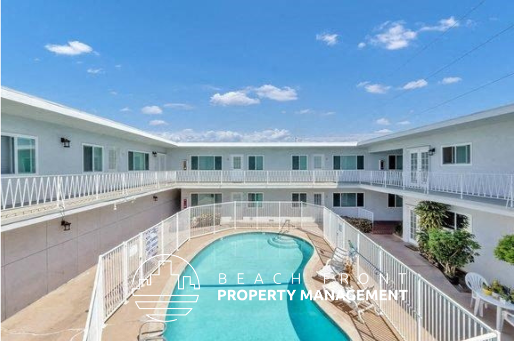 a view of a pool and a building with a balcony