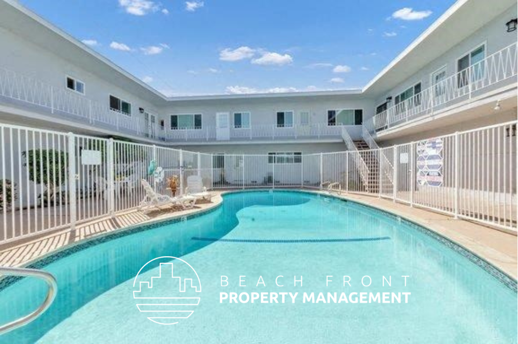 a resort style swimming pool is next to a building with white fences and a balcony