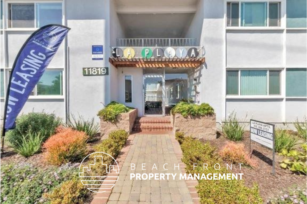 a view of the front of a building with a beach front property management sign