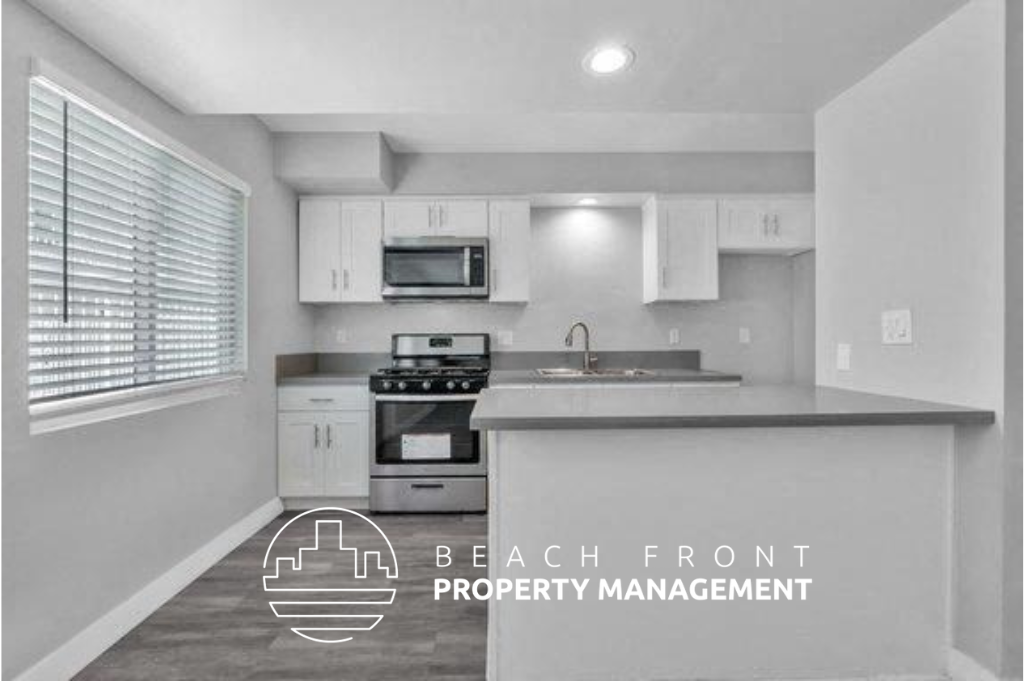 a kitchen with white cabinets and a counter top