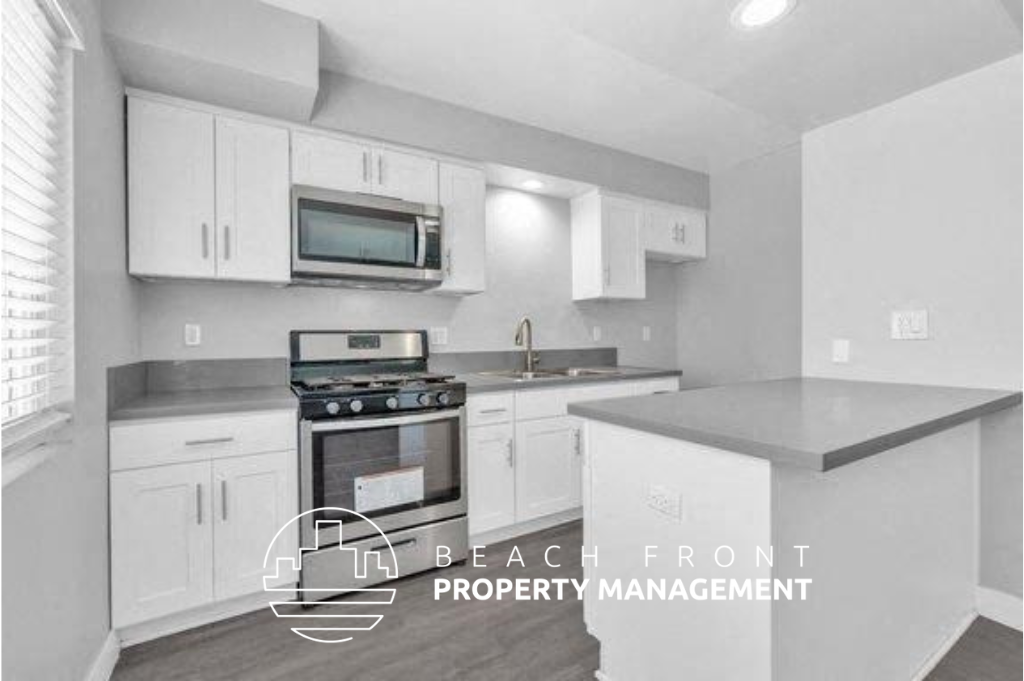 a kitchen with white cabinets and a stove and a microwave