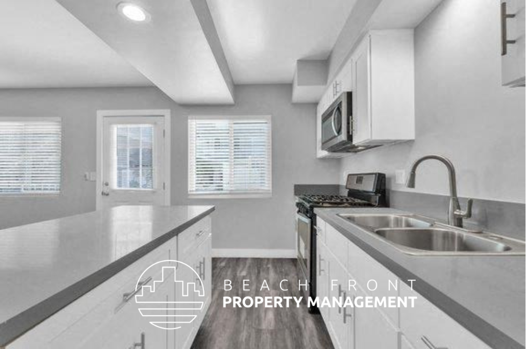a kitchen with white cabinets and a sink and a microwave