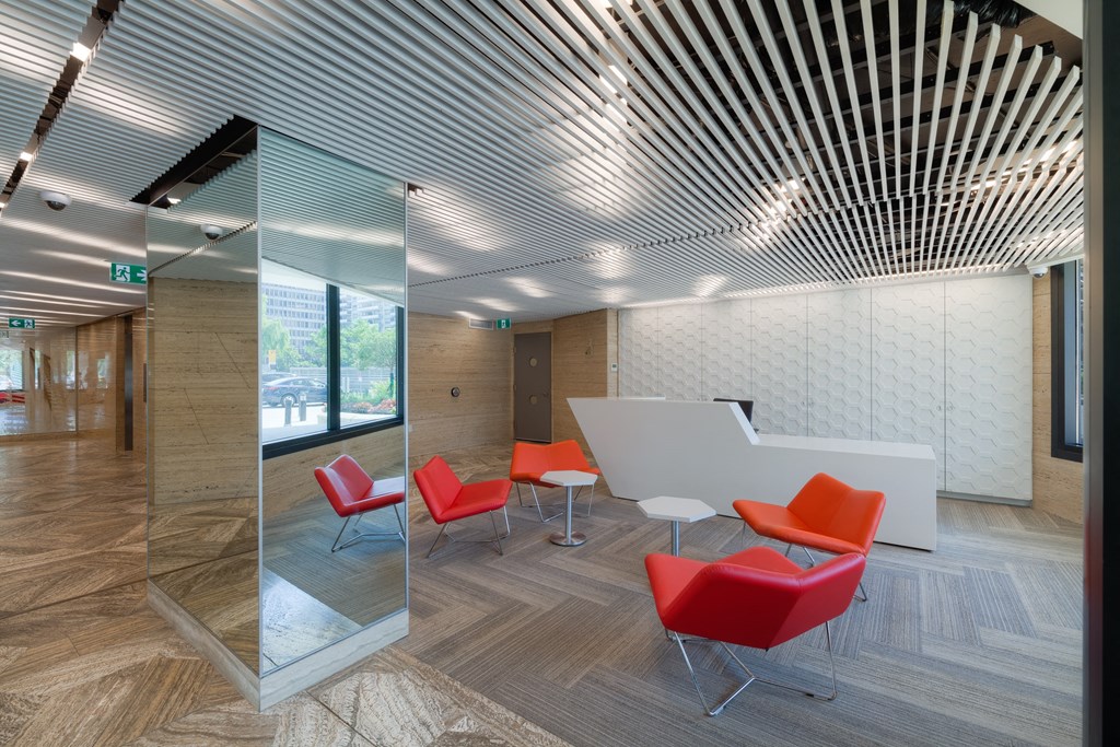 a large room with red chairs and a white table