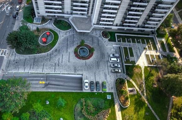 an aerial view of a parking lot with cars