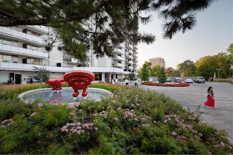 a fountain in a park next to a building