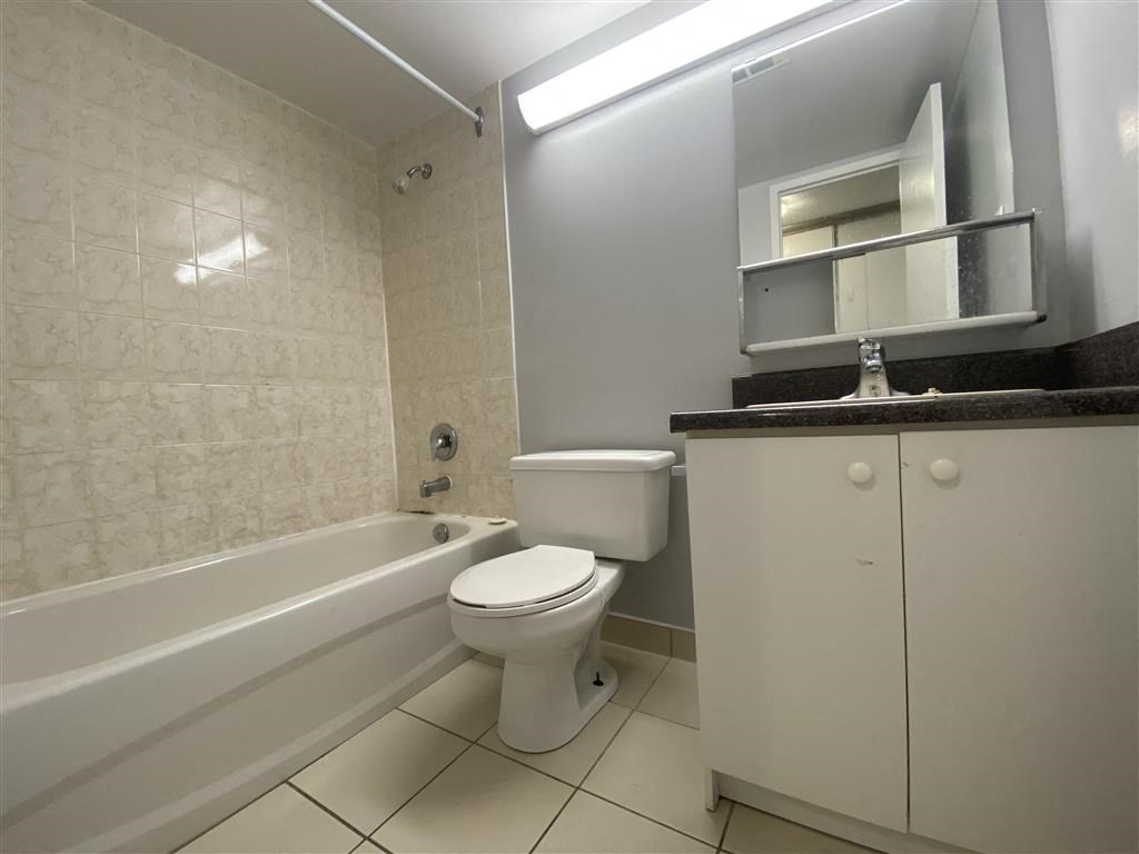 a bathroom with a toilet and a bath tub