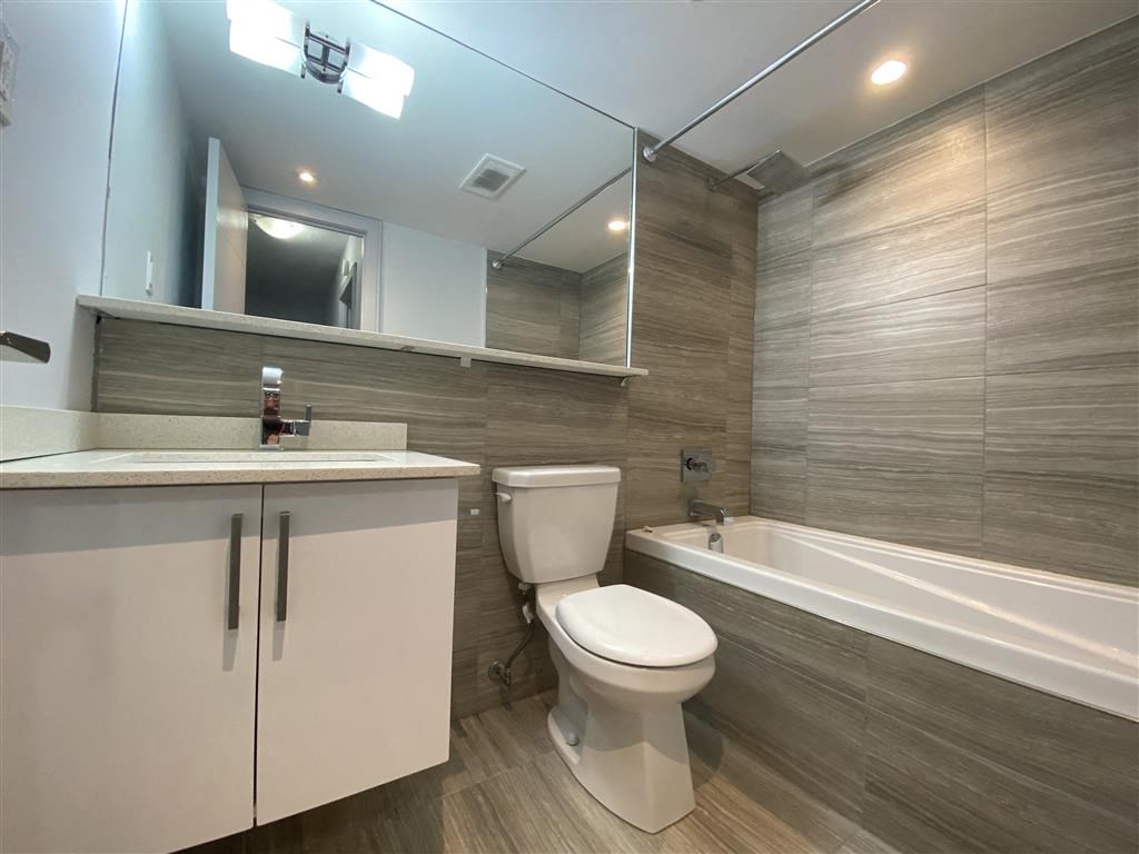 a bathroom with a toilet and a sink and a bath tub