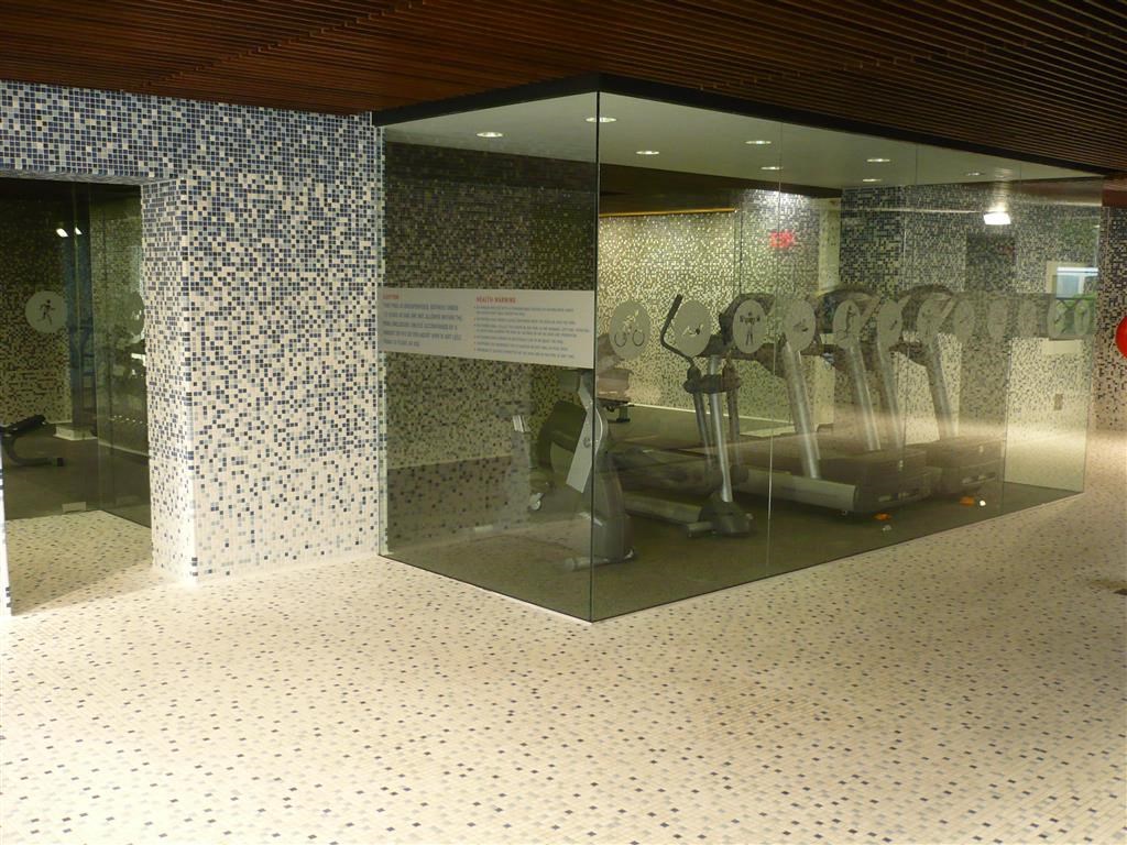 a glass case with a bunch of golf clubs in it