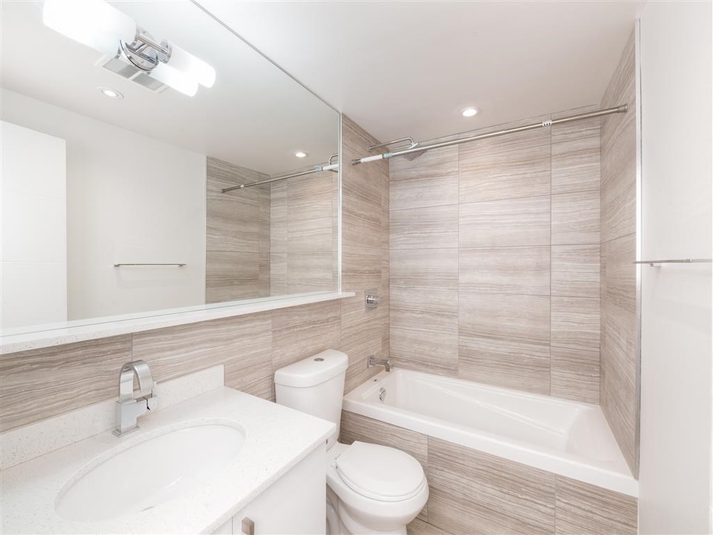 a bathroom with a sink toilet and a bath tub