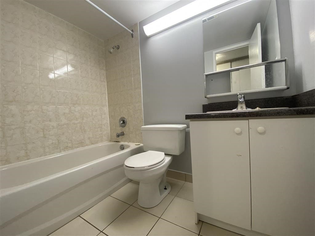 a bathroom with a toilet and a bath tub
