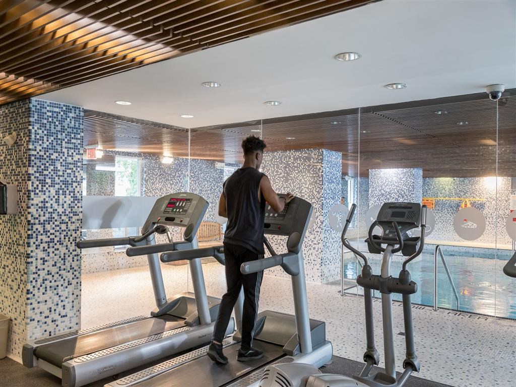 a man running on a treadmill in a gym