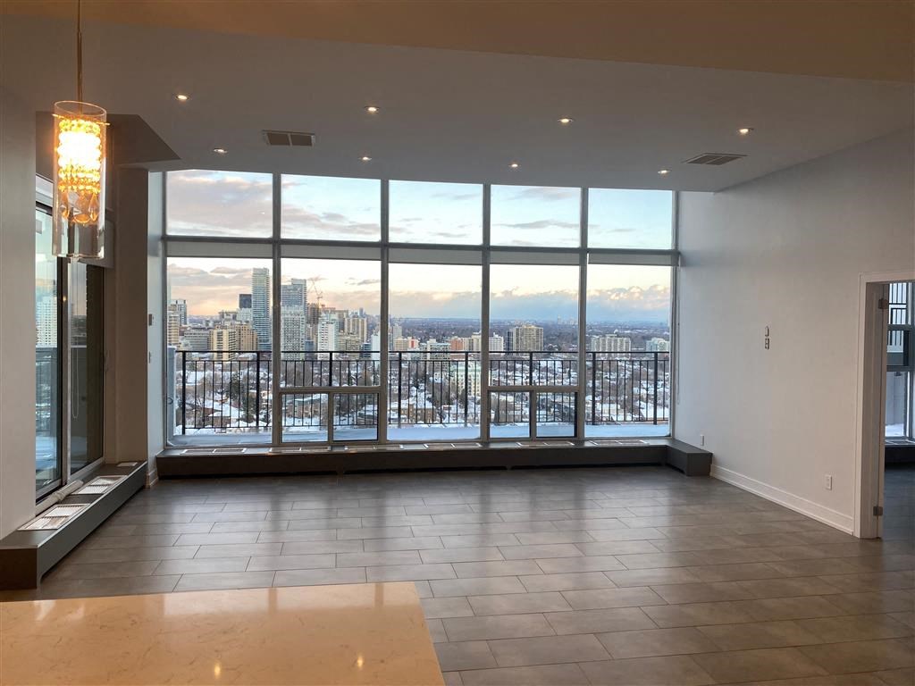 the view of the city from the living room of an empty apartment