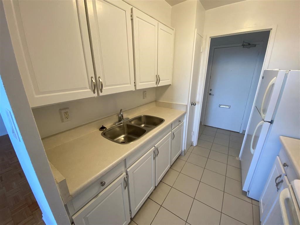 a kitchen with a sink and white cabinets